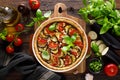 Tart with vegetables. Homemade savory tart with eggplant, zucchini, tomatoes, garlic, mozzarella cheese and fresh basil. Mediterra Royalty Free Stock Photo