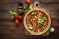 Tart with vegetables. Homemade savory tart with eggplant, zucchini, tomatoes, garlic, mozzarella cheese and fresh basil. Mediterra Royalty Free Stock Photo