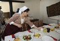 At the Tartar restaurant: waitress in Tartar native dress setting the table