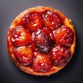 Tarte tatin, upside down apple tart, traditional french apple pie with caramelized apples on black background, top view. Created