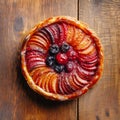 Tarte tatin, upside down apple tart, traditional french apple pie with caramelized apples on wooden background, top view. Created