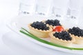 Tartlet with black caviar on a white platter