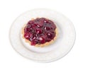 Tartlet with cherry and fruit jelly in a white plate.