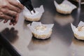 Tartlet with a meringue and kitchen torch blowtorch with blue flame. woman hand holdings blowtorch. bakery concept Royalty Free Stock Photo