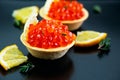 Tartlet with red caviar and butter close up. Snacks with red caviar, gourmet food, appetizer in a restaurant Royalty Free Stock Photo