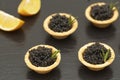 Tartlets with black caviar close up. Gourmet food close up, appetizer. Delicatessen. Gourmet food. Texture of caviar.