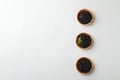 Tartlets with black caviar on white background, space for text Royalty Free Stock Photo