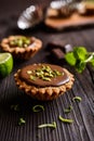 Tartlets with chocolate, pistachios and lime peel Royalty Free Stock Photo