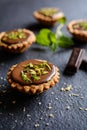 Tartlets with chocolate, pistachios and lime peel Royalty Free Stock Photo