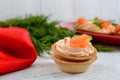 Tartlets with cream cheese and salted salm on a white wooden background. Tasty light snack for a party.