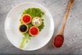 Tartlets filled with red and black caviar and cheese and dill salad on white plate against rustic wooden background Royalty Free Stock Photo