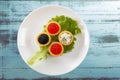 Tartlets filled with red and black caviar and cheese and dill salad on white plate against rustic wooden background Royalty Free Stock Photo