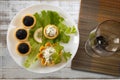 Tartlets filled with red and black caviar and cheese and dill salad on white plate against silver wooden background Royalty Free Stock Photo