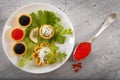 Tartlets filled with red and black caviar and cheese and dill salad on white plate against silver wooden background Royalty Free Stock Photo