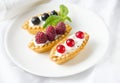 Tartlets with fresh berries and whipped cream