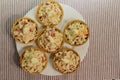 Tartlets with snack on white plate