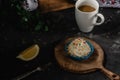 Tartlets with whipped cream, with lemon, coffee americano, wooden basket and green leaves
