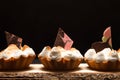 Tartlets with white cream and chocolate on the board on a dark b Royalty Free Stock Photo