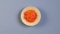 Tartrazine powder in wooden plate, top view. Food coloring. Food additive E102.