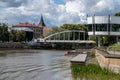 Tartu, Estonia - July 16, 2022: Arch Bridge Estonian Kaarsild over the Emajogi River and Atlantis house Estonian Royalty Free Stock Photo