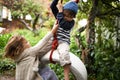 Tarzan and Jane. two cute kids playing on a tire swing in their garden. Royalty Free Stock Photo