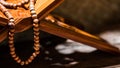 Tasbih or Islamic prayer beads on rehal or Quran wooden book stand