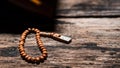 Tasbih or Islamic prayer beads on rustic wooden surface