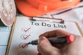 Check off a to do list on a construction site as a symbol for organized work Royalty Free Stock Photo