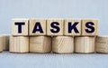 TASKS - word on wooden cubes on a beautiful gray background