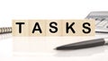 TASKS a word written on wooden cubes on a white background. Business concept