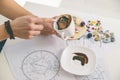 Tasseography: empty coffee cup, natal charts, runes and magic stones on table Royalty Free Stock Photo