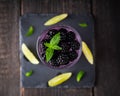 Taste of forest with gin based cocktail with blackberry liqueur and berries. Selective focus