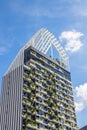 A tastefully contemporary green facade of a multi-storey building