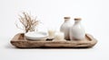 A tastefully curated ensemble of rustic home decor items, featuring white vases, candles, and a tray, exuding a sense of warmth