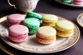 A table is graced with a plate laden with an assortment of delectable macarons.