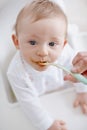 This tastes good. High angle view of a baby boy being fed by his mother.