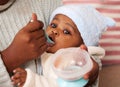 Tastes like more. an adorable baby girl being fed by her mother at home. Royalty Free Stock Photo