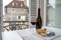 Tasting of burgundy red wine from grand cru pinot noir vineyards with french goat cheeses and view on old town street in Burgundy