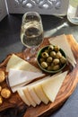 Tasting of fortified Andalusian sherry wine with traditional Spanisch tapas, green olives, goat and sheep manchego cheese Royalty Free Stock Photo