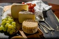 Tasting of oldest french AOC soft pudgent yellow cheese Livarot, Royalty Free Stock Photo