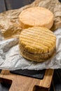 Tasting of oldest french AOC soft pudgent yellow cheese Livarot Royalty Free Stock Photo