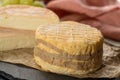 Tasting of oldest french AOC soft pudgent yellow cheese Livarot Royalty Free Stock Photo