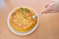 Tasting a pinch of spanish omelette