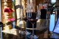 Tasting of red dry wine in Chateauneuf-du-Pape wine making village in France with green vineyards on large pebbles galets and