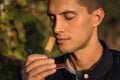 Young man smelling red wine cork. tasting wine Royalty Free Stock Photo