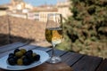 Tasting of Spanish sweet and dry fortified Vino de Jerez sherry wine and olives with view on roofs and houses of old andalusian Royalty Free Stock Photo