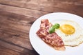 Tastu fried egg in plate with bacon Royalty Free Stock Photo