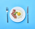 Tastu fried egg in plate with bacon Royalty Free Stock Photo