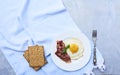 Tastu fried egg in plate with bacon Royalty Free Stock Photo