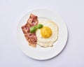 Tastu fried egg in plate with bacon Royalty Free Stock Photo